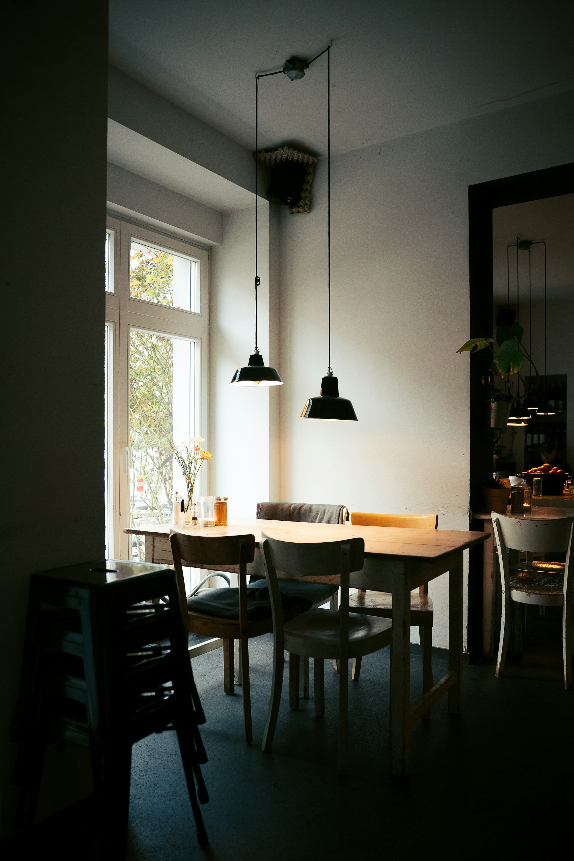 Cafe interior with tables and chairs near window